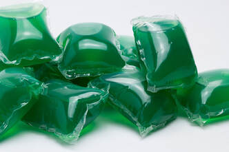 Green detergent pods on a white background